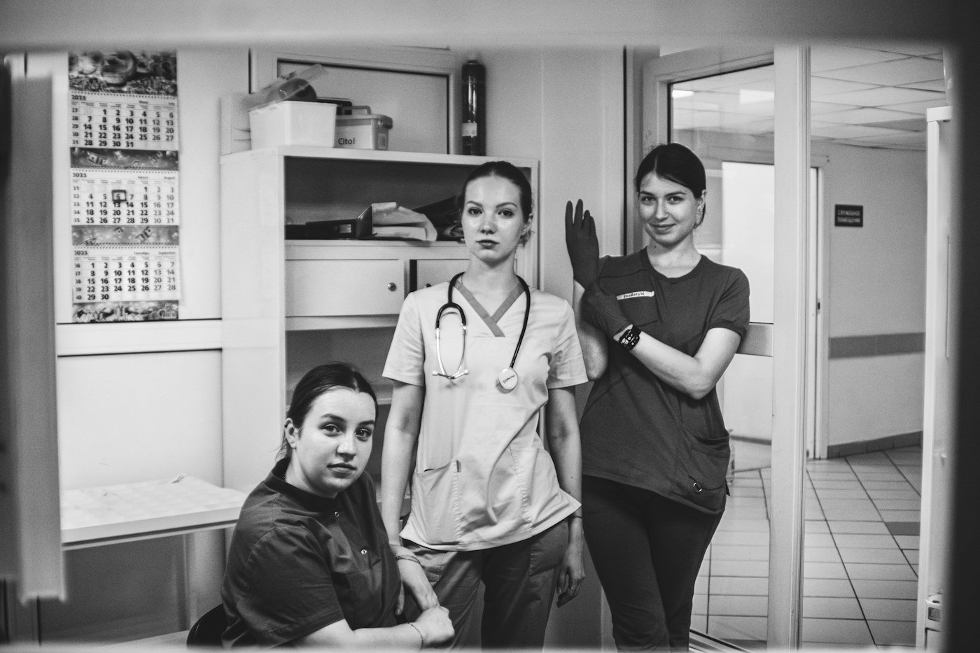 Group of clinicians in white coats in a hospital hallway